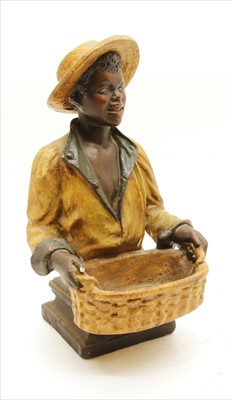 Lot 485 - A polychrome decorated figure of a boy with a basket