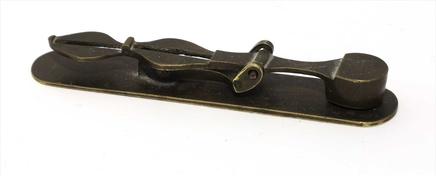 Lot 1194 - A brass folding column rocker