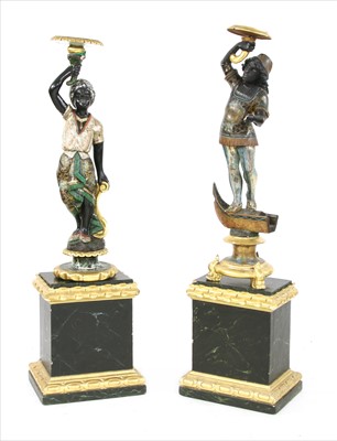 Lot 885 - A near pair of carved polychrome blackamoors and stands