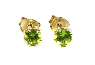 Lot 94 - A pair of gold single stone peridot stud earrings
