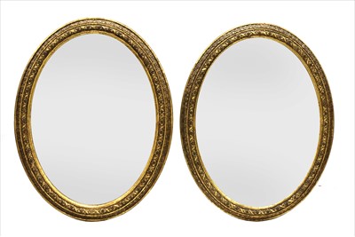 Lot 764 - A pair of gilt oval wall mirrors