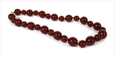 Lot 70 - A single row cherry coloured spherical Bakelite bead necklace