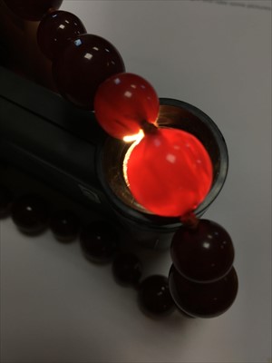 Lot 70 - A single row cherry coloured spherical Bakelite bead necklace