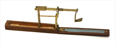 Lot 1038 - A mahogany cased brass single arm folding sovereign balance