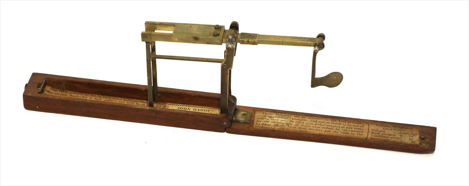 Lot 1044 - A mahogany cased folding brass coin scale