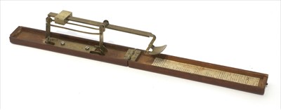 Lot 1048 - A mahogany cased brass folding coin scale