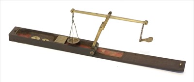 Lot 1053 - A rosewood cased brass folding coin scale