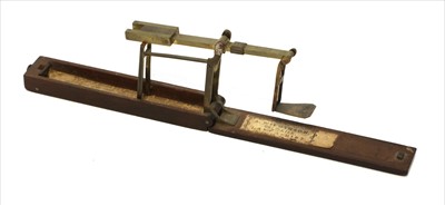 Lot 1061 - A mahogany cased brass folding brass scale