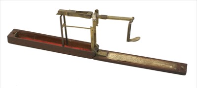 Lot 1062 - A mahogany cased brass folding coin scale