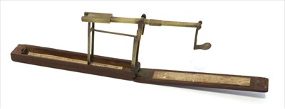 Lot 1066 - A mahogany cased brass folding coin scale