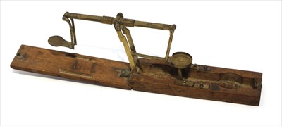 Lot 1069 - A mahogany cased brass equal arm guinea scale