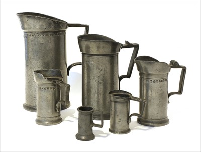 Lot 1100 - A set of six pewter measures