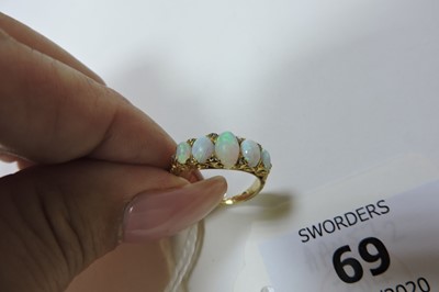 Lot 69 - A Victorian gold five stone opal carved head ring