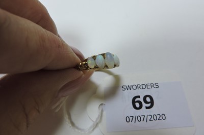 Lot 69 - A Victorian gold five stone opal carved head ring