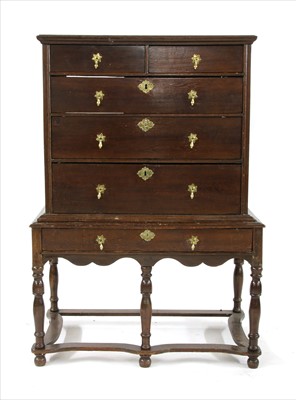 Lot 485 - An 18th century oak chest on stand