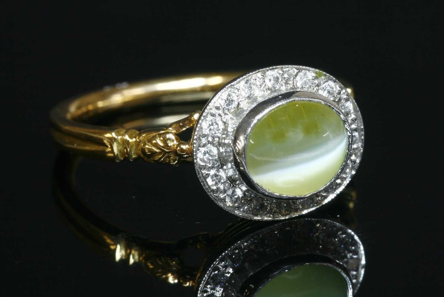 Lot 96 - An 18ct yellow and white gold chrysoberyl cat's eye and diamond oval cluster ring