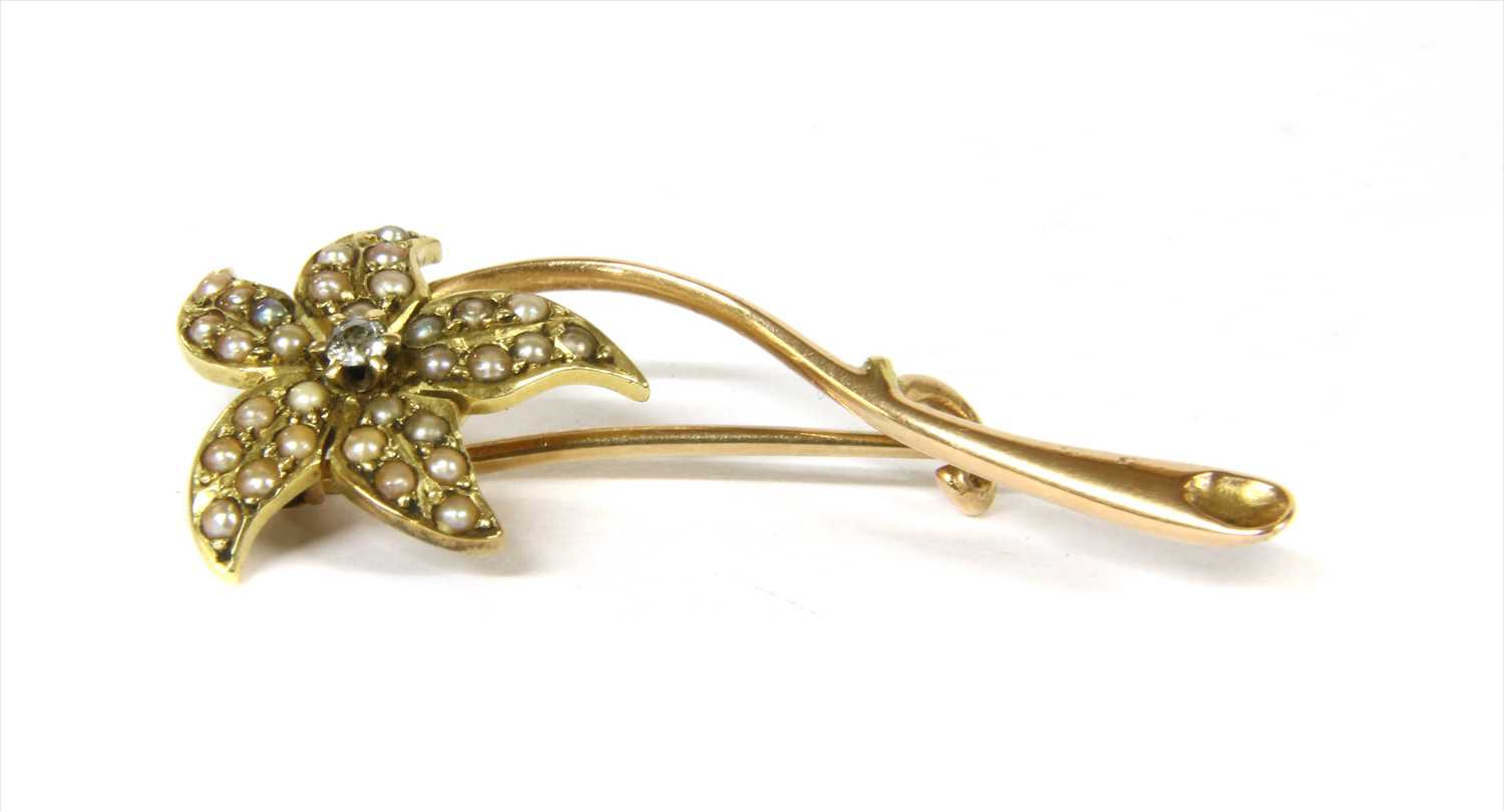 Lot 13 - A gold diamond and split pearl floral brooch