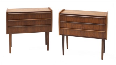 Lot 673 - A pair of Danish teak three-drawer bedside cabinets