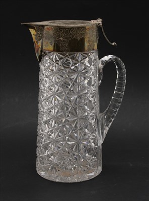 Lot 136 - An Edwardian cut glass and silver mounted claret jug in the manner of Thomas Webb