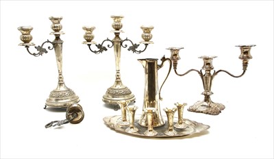 Lot 133 - A pair of white metal candelabra