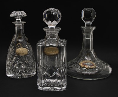Lot 192 - A group of three crystal glass decanters