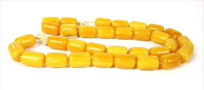 Lot 74 - A single row uniform cylindrical amber coloured Bakelite bead necklace