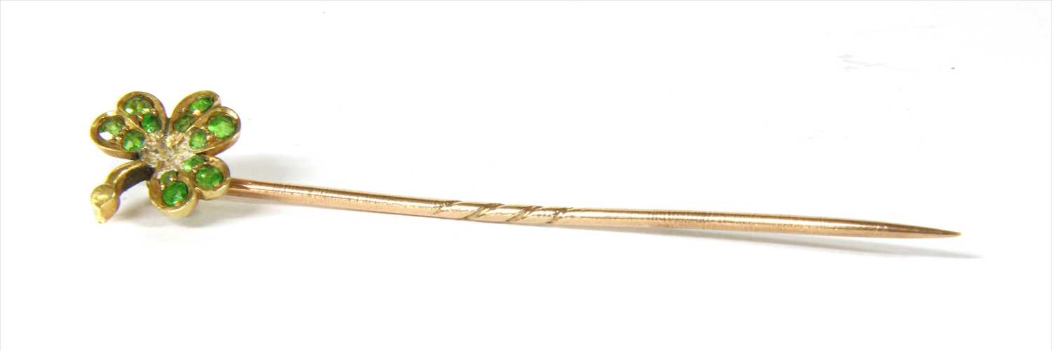 Lot 16 - A gold demantoid garnet shamrock stick pin