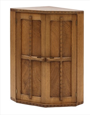 Lot 239 - An oak hanging corner cupboard
