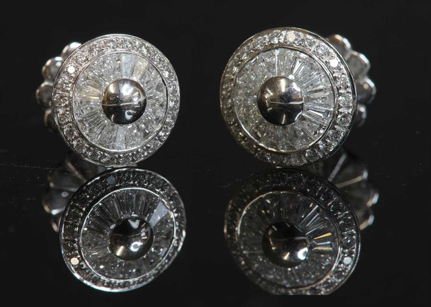 Lot 313 - A pair of diamond set target-style disc stud earrings