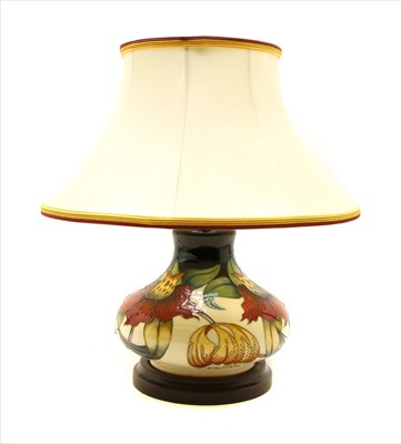 Lot 310 - A Moorcroft tubeline decorated 'Anna Lily' pattern table lamp
