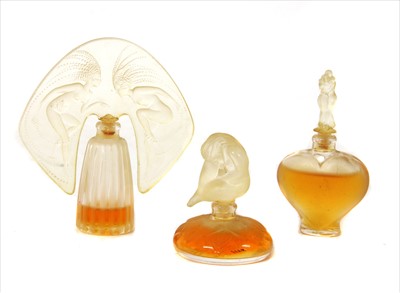 Lot 1186 - A set of three Lalique Art Nouveau style miniature perfume bottles