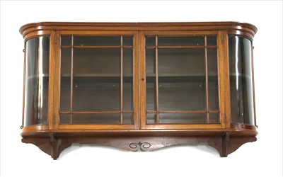 Lot 493A - A late 19th century walnut bow fronted glazed hanging wall cabinet