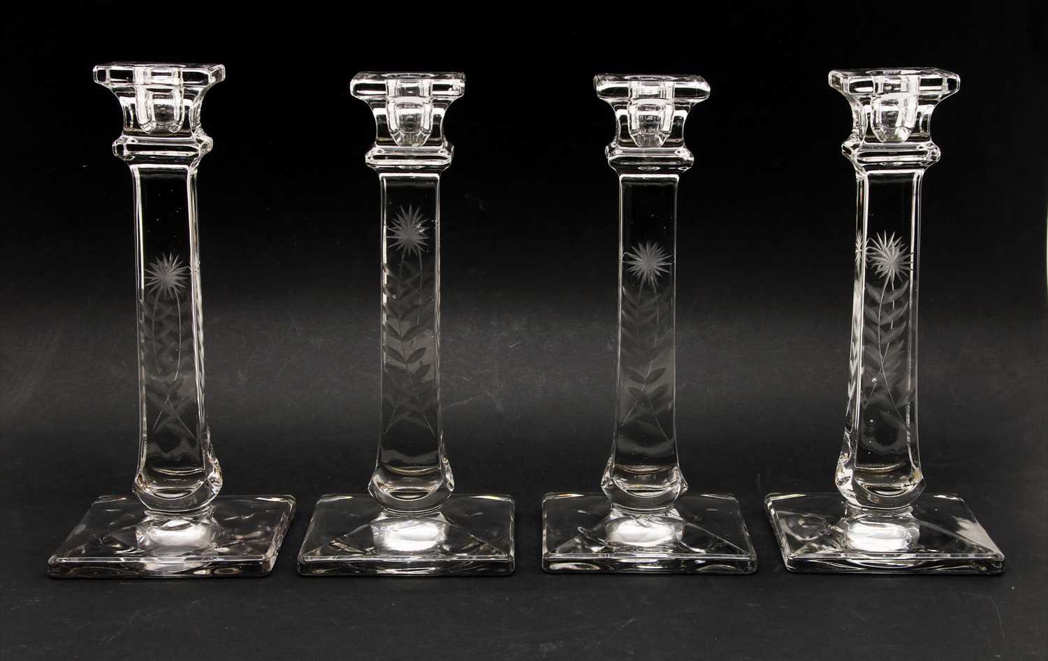 Lot 187 - A set of four etched glass candlesticks