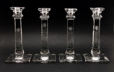 Lot 187 - A set of four etched glass candlesticks