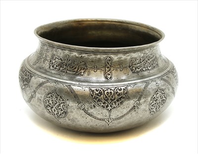 Lot 140 - A middle eastern white metal decorated with with calligraphic frieze