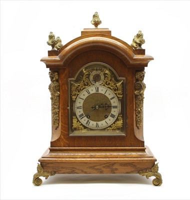 Lot 238 - An oak cased mantel clock