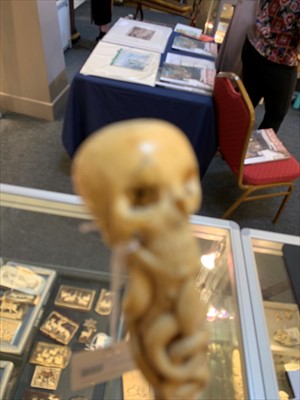 Lot 185 - A carved ivory skull and snake walking stick