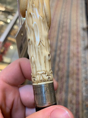 Lot 185 - A carved ivory skull and snake walking stick