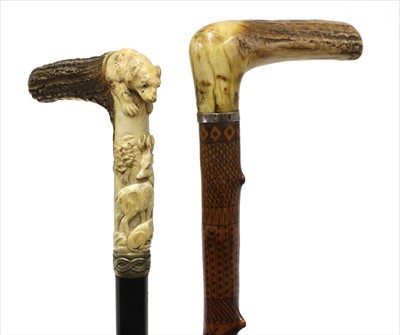 Lot 136 - Two carved antler-handled walking sticks