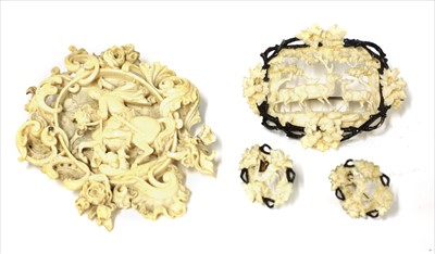 Lot 144 - Two carved ivory brooches and a pair of earrings