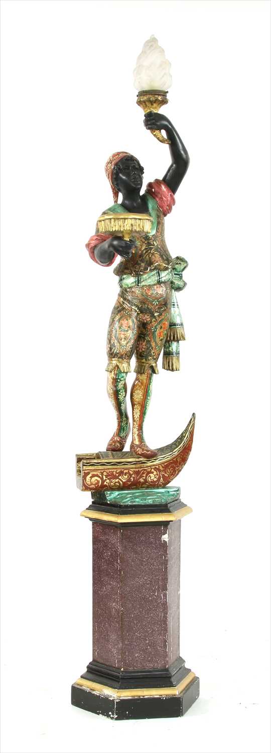 Lot 922 - A carved and polychrome painted blackmoor lamp