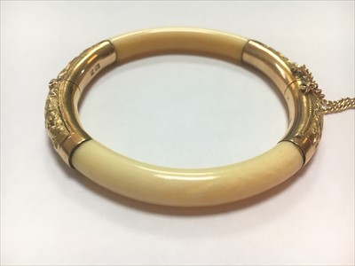 Lot 6 - An early 20th century Chinese carved ivory and gold mounted hinged bangle