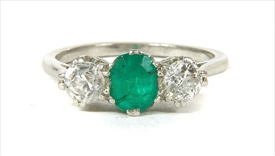 Lot 43 - A three stone emerald and diamond ring