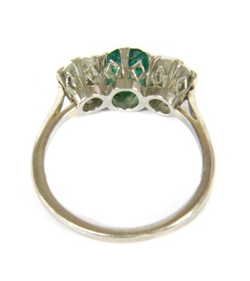 Lot 43 - A three stone emerald and diamond ring