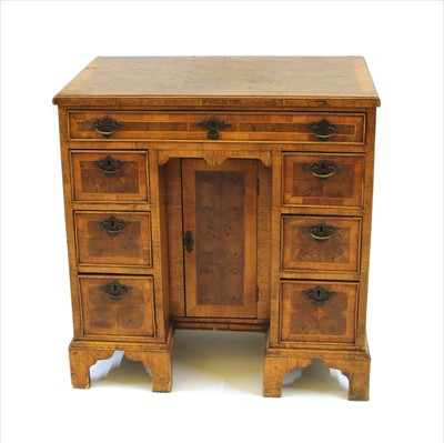 Lot 408 - A George III style walnut and oyster veneered knee hole desk