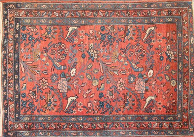 Lot 465 - A small red ground rug