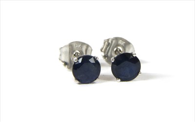 Lot 70 - A pair of white gold single stone sapphire stud earrings
