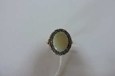 Lot 221 - An 18ct gold opal and diamond oval cluster ring