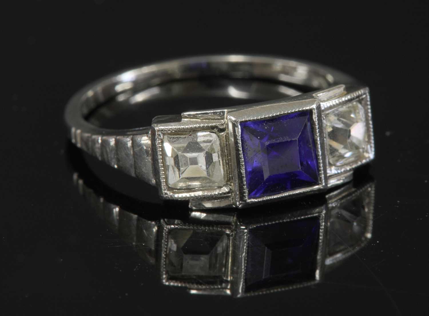 Lot 123 - An Austrian Art Deco three stone synthetic sapphire and diamond ring