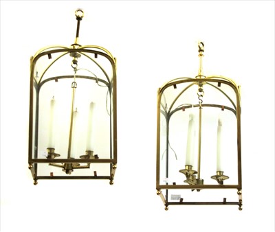 Lot 240 - A pair of brass three light hall lanterns